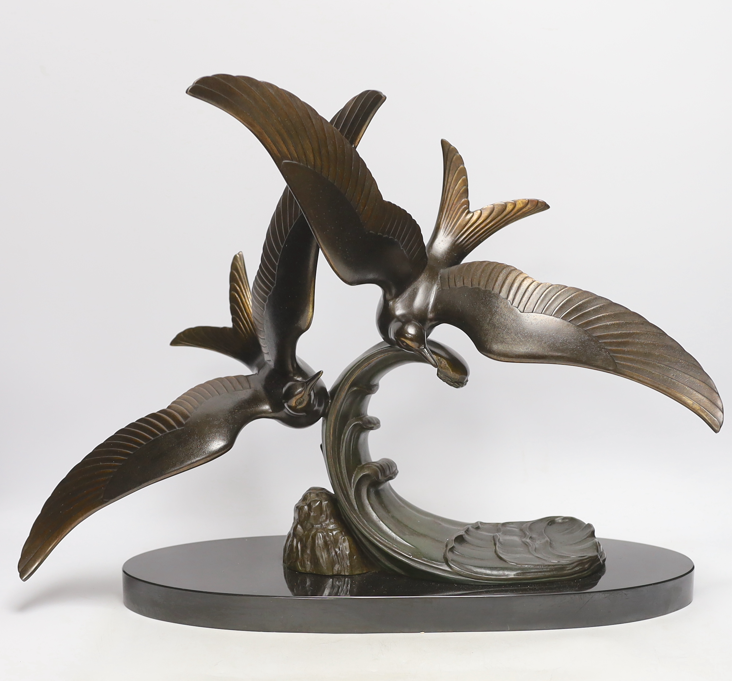 An Art Deco patinated spelter seagull group, signed Trebig, raised on slate base, 48cm wide